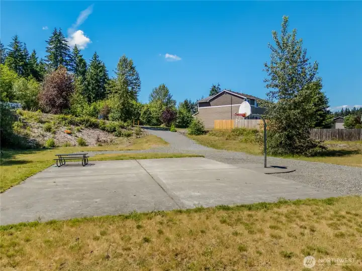 The neighborhood features a sports court with a basketball hoop.