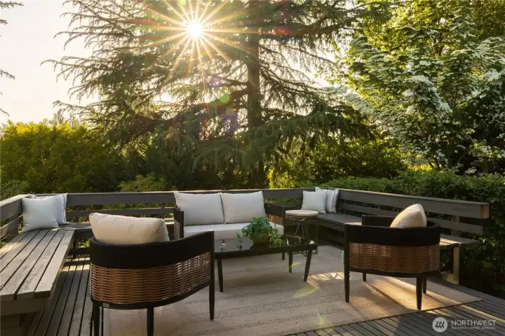 Expansive deck with built-in seating overlooking back yard