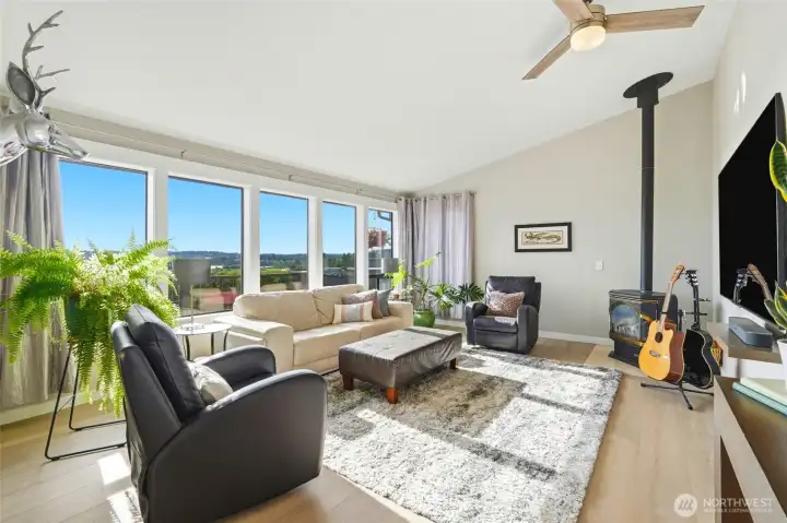 Main level living room with gas fireplace and panoramic bay and mountain view