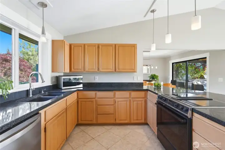 Kitchen with black granite and pendant lighting