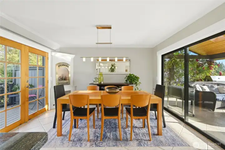 Dining room with corner gas fireplace, access to outdoor living space and private back yard