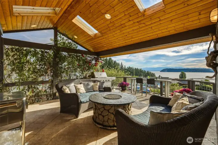 Covered deck with vaulted ceiling and west facing view of Puget Sound and Olympic Mountains