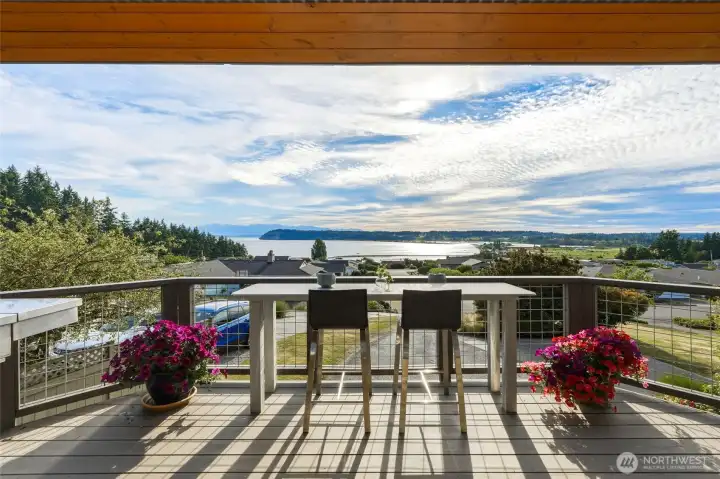 Water and mountain views of Useless Bay, Double Bluff and Olympic Mountains from covered entertainment deck