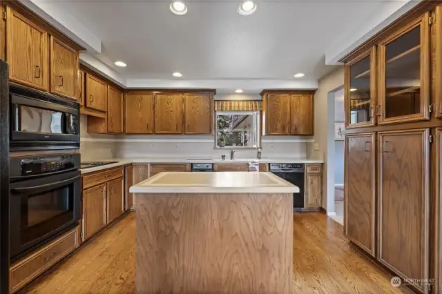 Kitchen with an island and plenty of cabinetry.