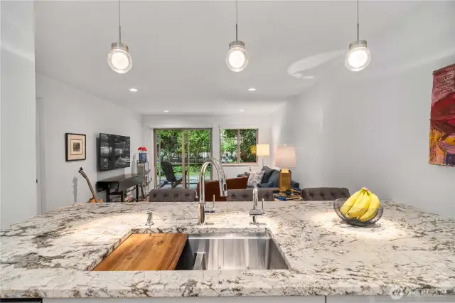 Gorgeous granite countertops are highlighted by stylish pendant lighting.