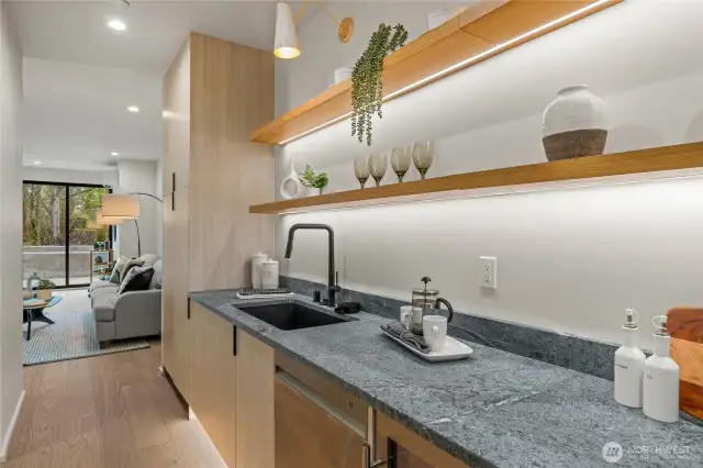 Kitchenette complete with beverage fridge, dishwasher and sink