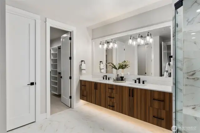 Primary Bedroom Bathroom has similar design, finishes, and color scheme as seen here, including the floating cabinet. (photo is a home recently built and sold by Builder)
