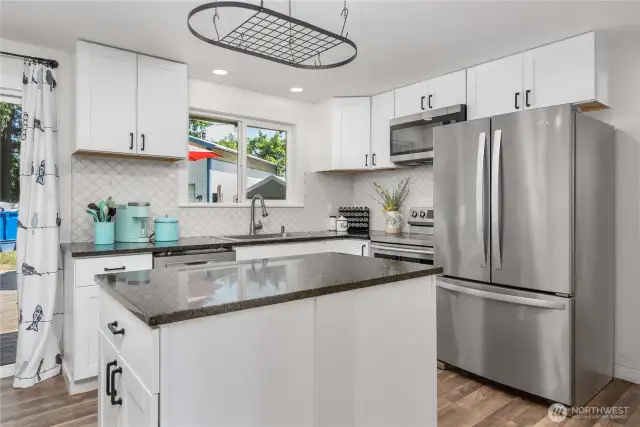 Kitchen has pot and pan hanger