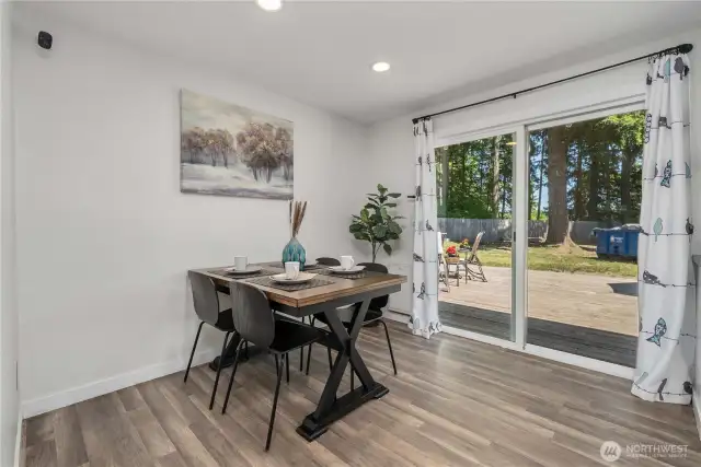 Dining room leads to the deck with an outdoor grilling station
