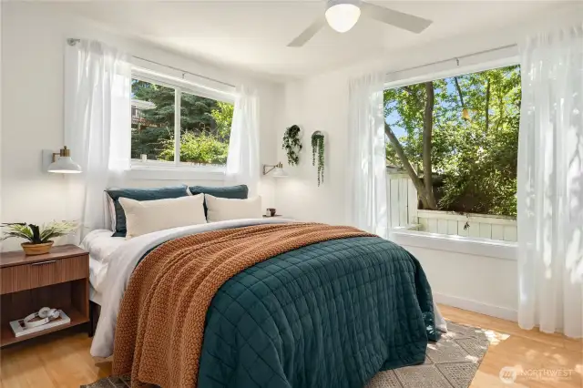 This main floor bedroom boasts 2 large windows and room for a king sized bed and has a large wardrobe closet off to the right.