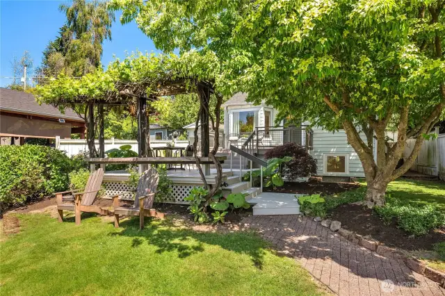 A nice sized lawn is just off the brick paver walkway that leads up to the main house.