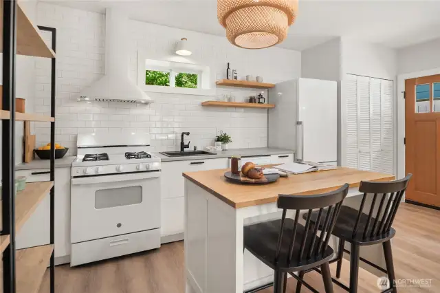The open racks on the left add fantastic storage to this already efficient and well thought through kitchen.