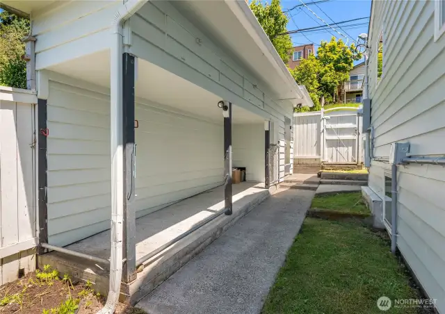 Off the main house is this detached storage shed and fantastic covered storage area.