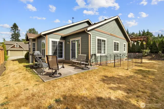 Backyard with a cement patio, perfect for entertaining or relaxing.