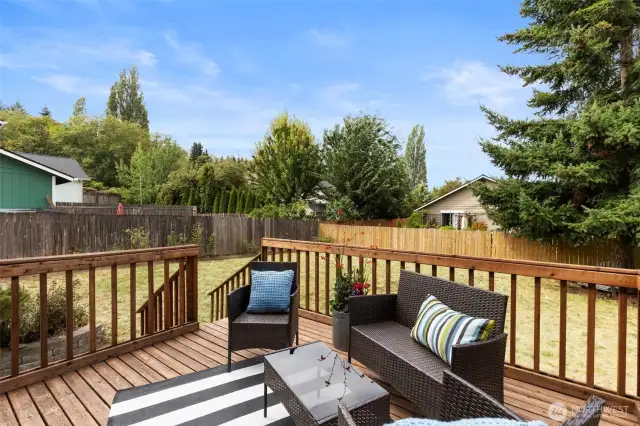 Sunny deck has room for your outdoor living furniture and grill. Steps down to your fenced and level yard.
