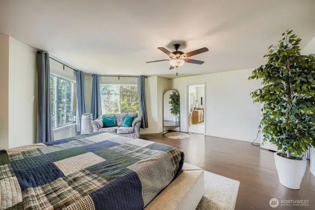 Large primary bedroom with tons of natural light