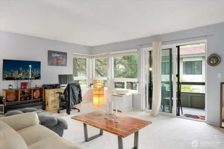 Light filled living room with views of mature landscaping. New carpeting!