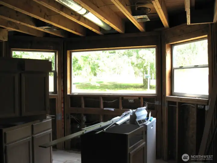 Kitchen area features a bay window looking out on the lushly, landscaped grounds