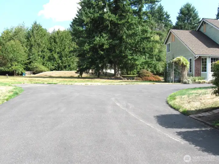 Spacious drive features a turn-around area.  To the south of the site is an RV  parking area