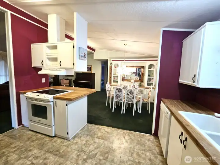 The kitchen seamlessly opens to both the dining room and living room, creating an inviting, connected layout that’s perfect for entertaining and everyday living.