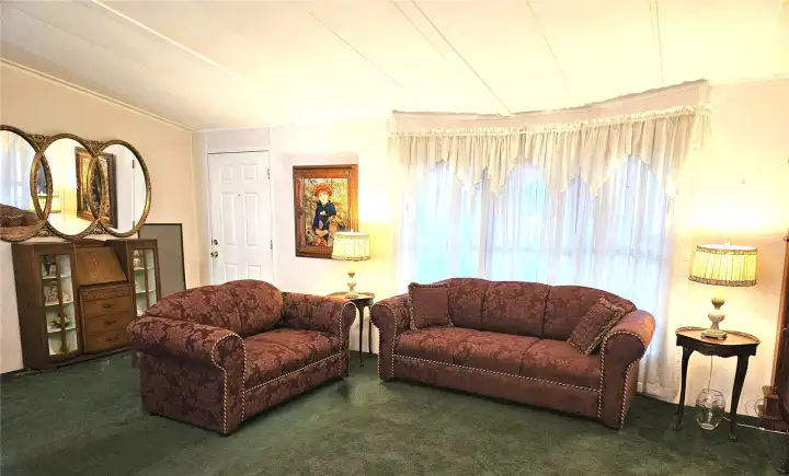 A spacious living room with vaulted ceilings that enhance the natural light and create an open, airy atmosphere—an inviting space for everyday living or entertaining.