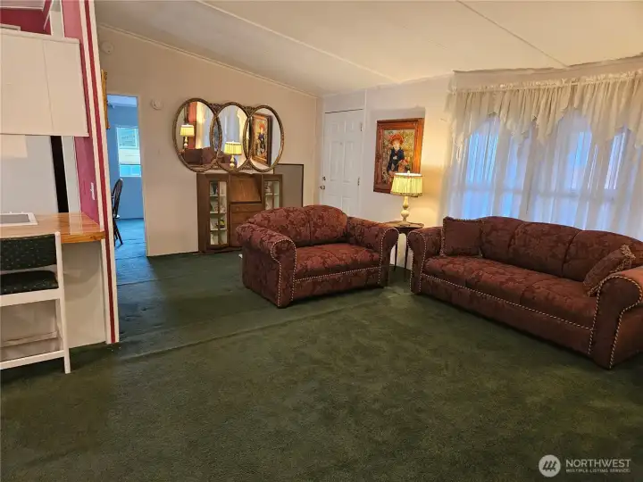 A spacious living room with vaulted ceilings that enhance the natural light and create an open, airy atmosphere—an inviting space for everyday living or entertaining.