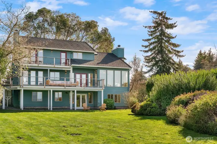 Stunning waterfront view residence with expansive grounds, mature landscaping, and panoramic views.