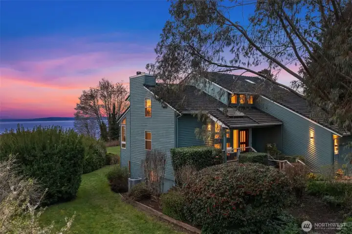 Beautiful evening exterior highlighting the home’s peaceful setting and scenic backdrop.