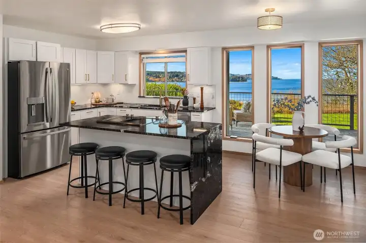 Modern kitchen with large island, ample seating, and open sightlines to living spaces.
