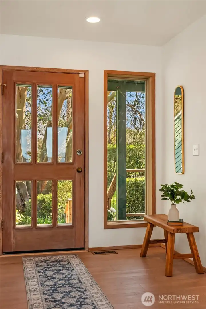 Welcoming entry foyer with natural light, warm finishes, and inviting first impression.