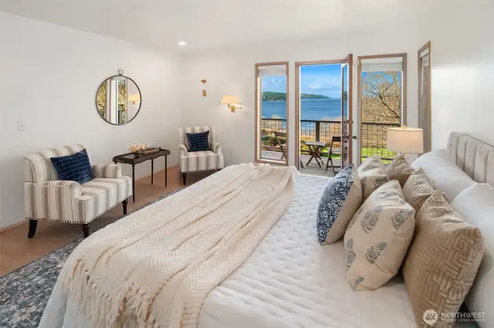 Light-filled primary suite with direct access to the view deck overlooking Tramp Harbor. Enjoy expansive water views, a private ensuite bath, and a spacious walk-in closet.