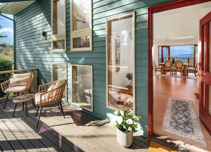 Outdoor deck with seating area and seamless connection to interior living spaces.