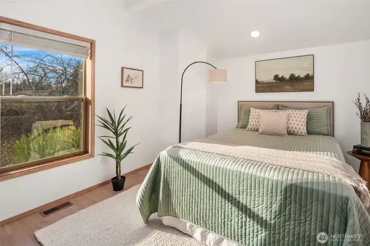 Bright and airy third bedroom with south-facing windows that fill the space with natural light throughout the day.