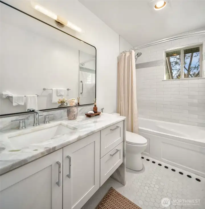 Updated upstairs bathroom with modern fixtures, and clean, bright finishes.