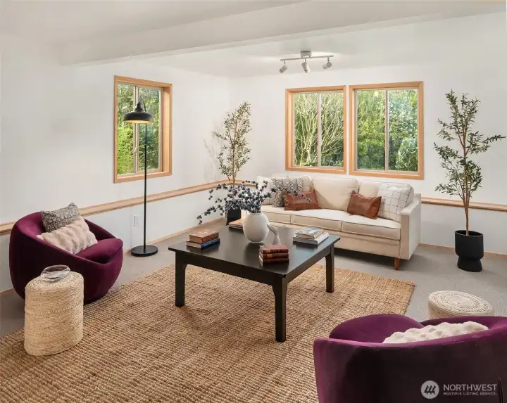 Versatile lower-level living space perfect for relaxing or entertaining, featuring a sauna, full bathroom, and plumbing in place for a future wet bar, with additional rooms for flexible use.