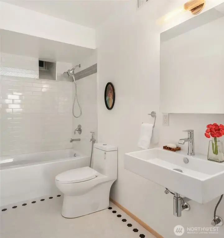 Bright and beautifully finished lower-level bathroom featuring a full tub/shower—adding comfort and convenience to this versatile living area.