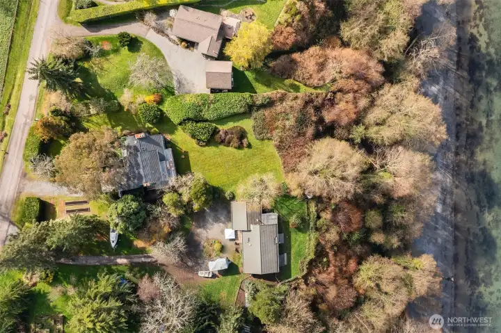 Overhead aerial of the property showcasing lot size, privacy, and surrounding landscape.