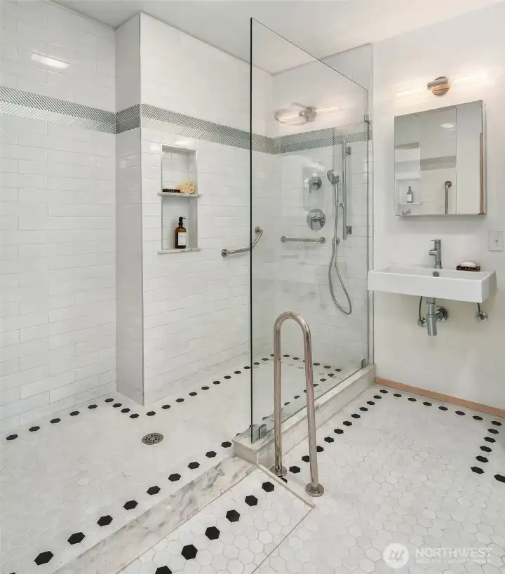 Updated bathroom with walk-in shower, modern fixtures, and clean, bright finishes.