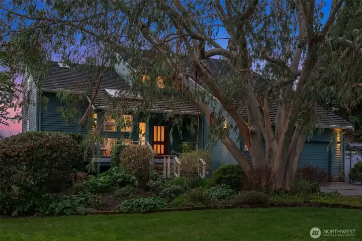 Exterior view highlighting mature trees, privacy, and tranquil island surroundings.