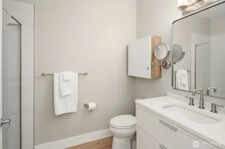Updated bathroom with larger shower and contemporary floating vanity