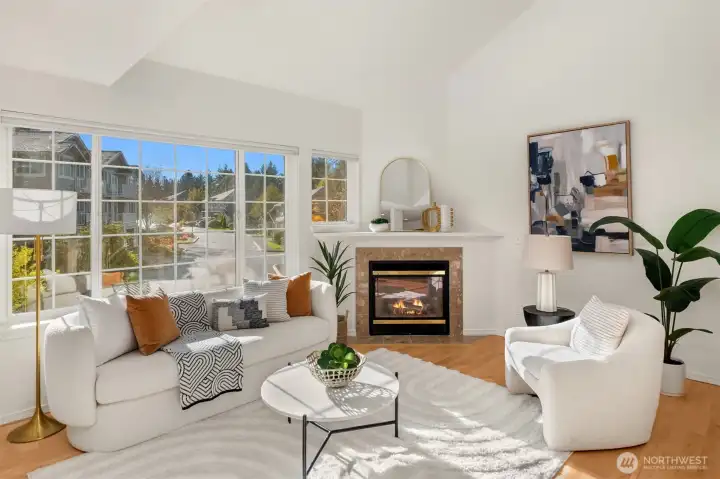 Sunlight pouring through large windows, the open floor plan, and hardwood floor throughout make it so comfortable to call home.