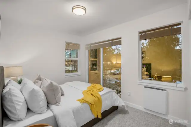The opposing secondary bedrooms features oversized windows and access to Juliet balcony. Photos of model home with similar layout, fit & finishes.