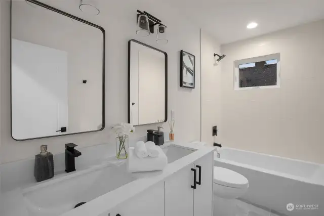 This guest bathroom is suited for hosting! Dual sink vanity, full bathtub, and under-sink storage come together to form the perfect guest retreat. Photos of model home with similar layout, fit & finishes.