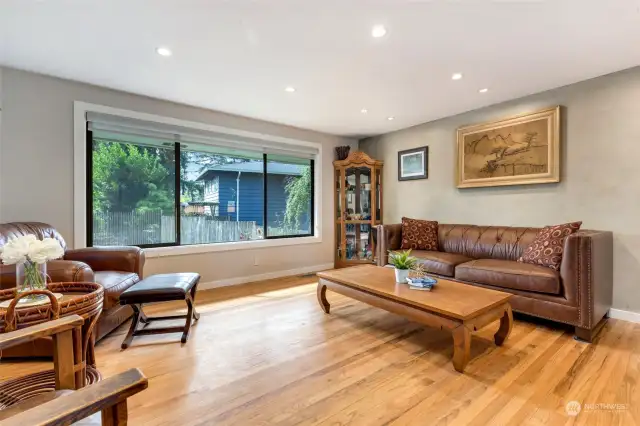 One view of the large living room area. Abundant light, hardwood floors and upgraded lighting throughout