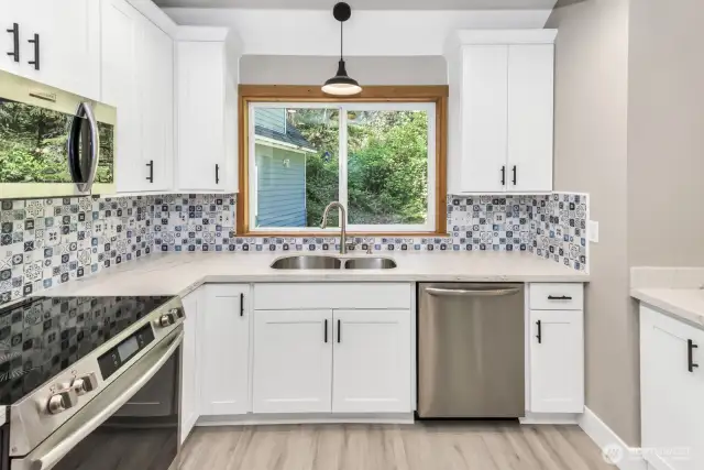 Main kitchen with brand new cabinets and appliances.