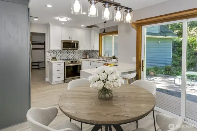 Virtually staged. Potential small dining room area off of main kitchen with room for a seat or two at kitchen peninsula.
