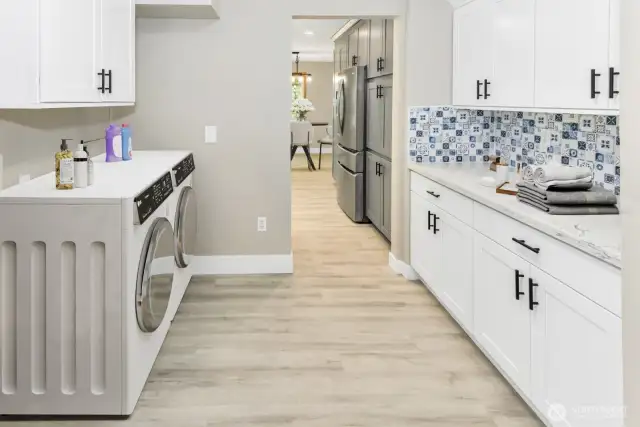 Virtually staged. Laundry room and prep kitchen off of the main kitchen.