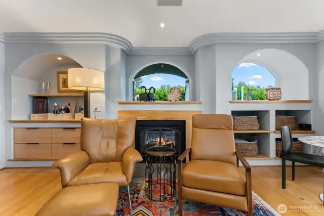 Custom built-ins w/ cozy gas indoor/ outdoor fireplace.