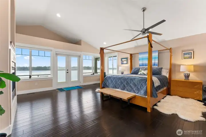Primary Bedroom on the upper level in the North Tower. Vaulted ceilings, windows with sweeping views! Double sided gas fireplace and private balcony.