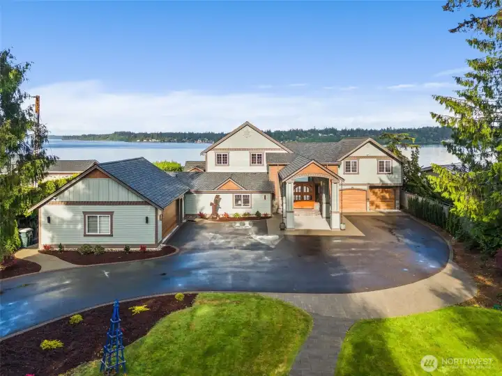 Immaculate curb appeal! New roof in 2021. New second garage on the left fully finished with EV charging.